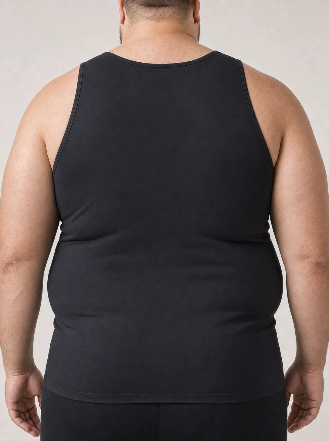 Back view of a man with a big and tall build wearing the Quietfit Big & Tall Builds compression tank, showing full back coverage