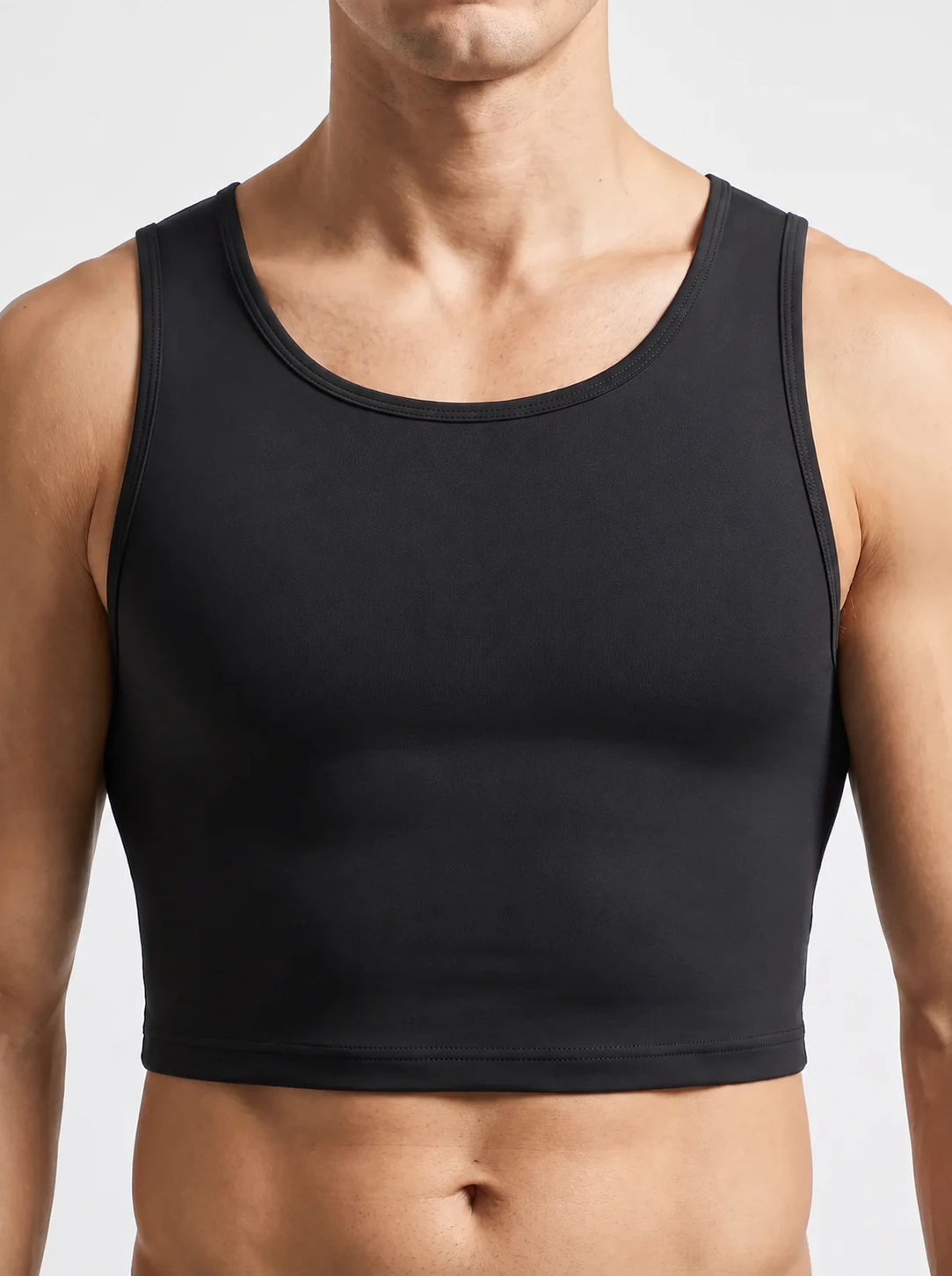 Man wearing the ContourFit Classic Crop Tank showing the flat, seamless front panel with no molded cup shape