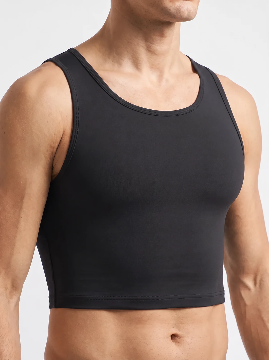 Close angle of a man wearing the ContourFit Classic Crop Tank, showing the flat compression front