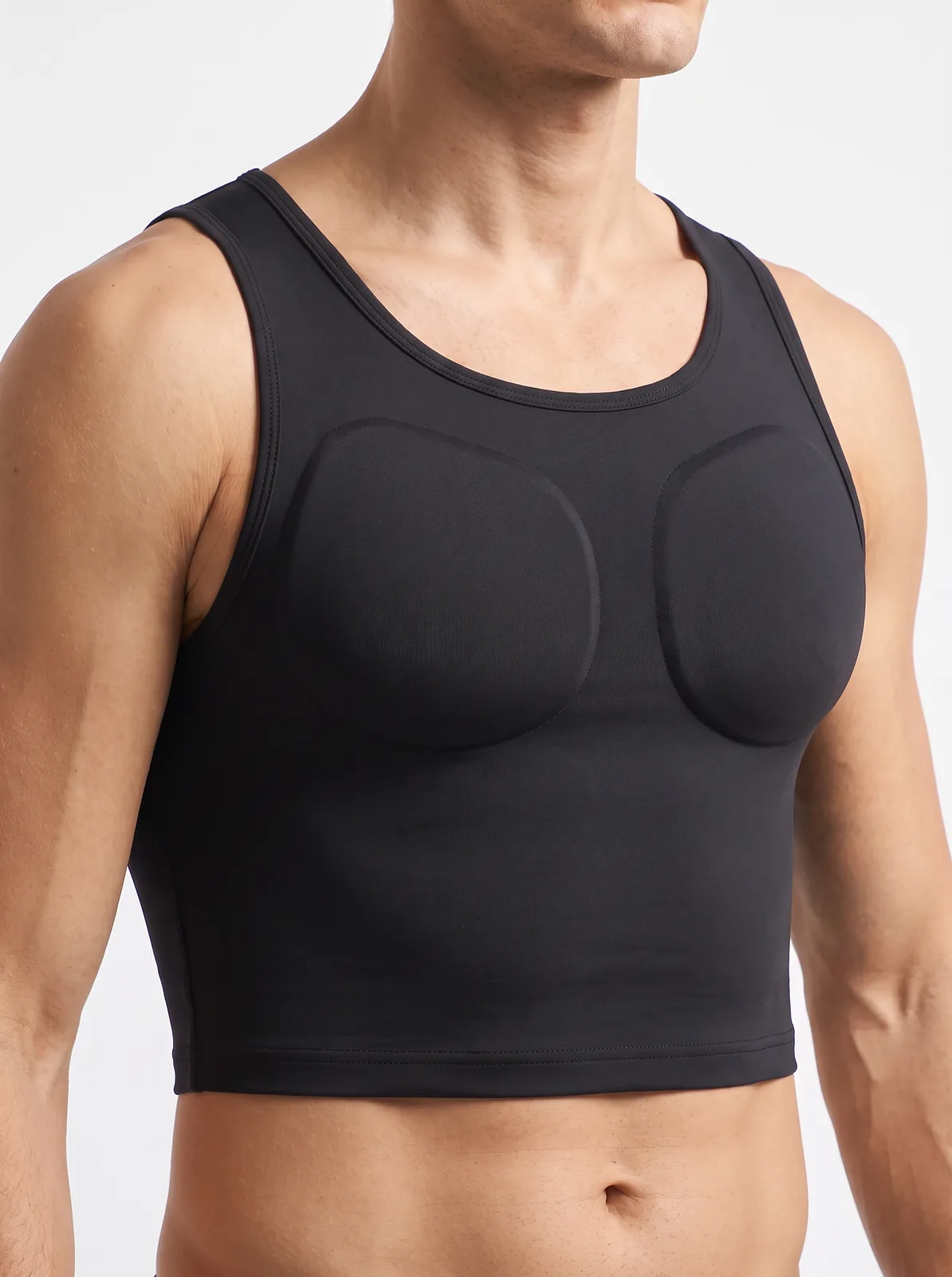 Side angle of a man wearing the ContourFit Crop Tank at the gym
